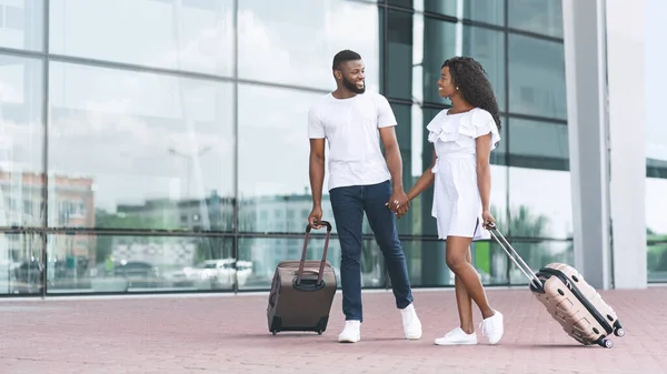 Couples holding hands while travelling